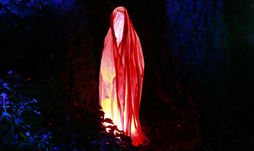 A sinister red spectre haunts a woodland at night. It appears as a hooded robe, empty(?), yet radiating evil. Original image by Humpelfinkel, c/o Pixabay.com, under the terms of the Pixabay License.